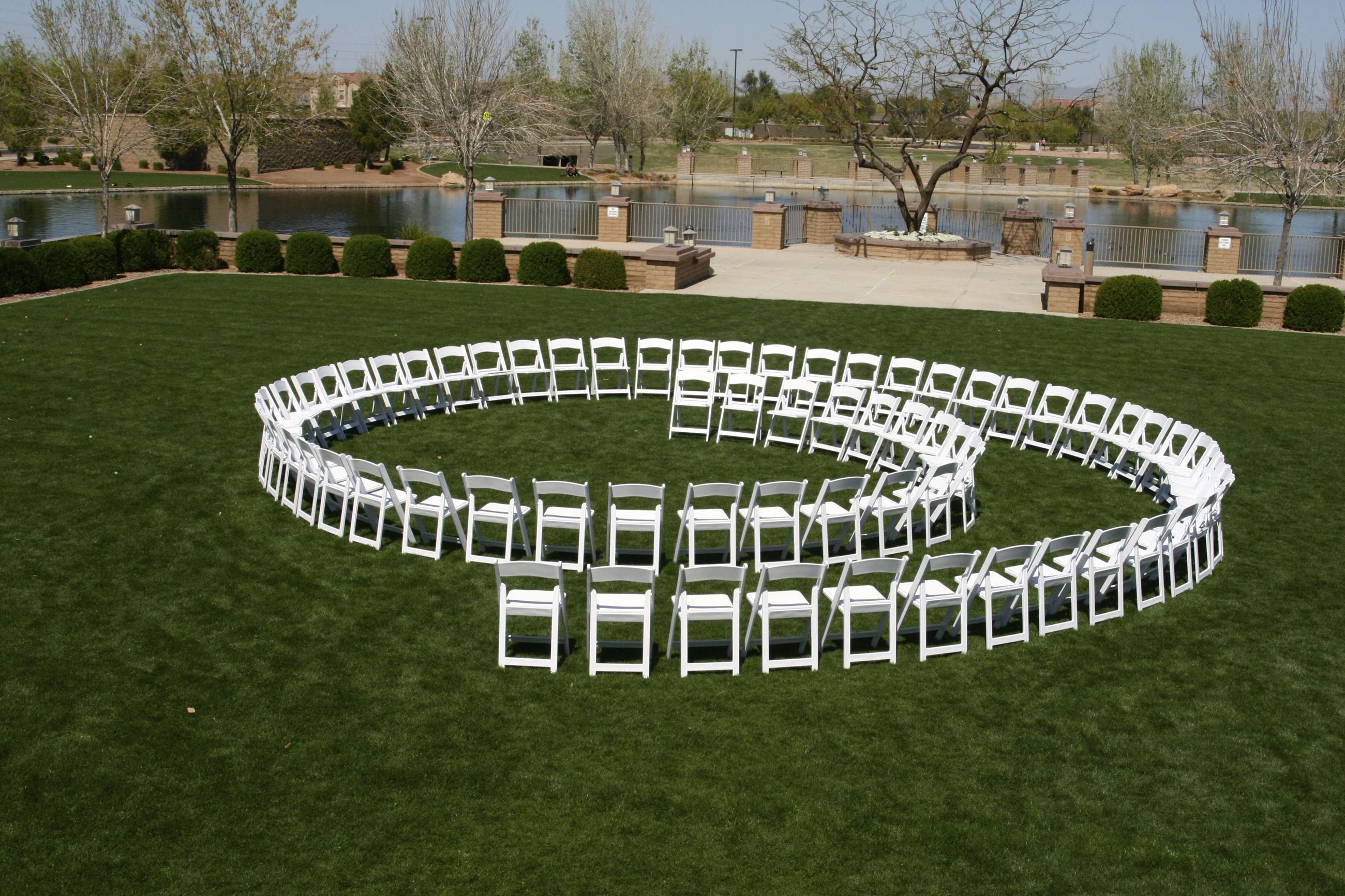 White Outdoor Chairs Set up in a Spiral