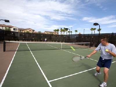 Man Returning a Ball at a Power Ranch Tennis Court